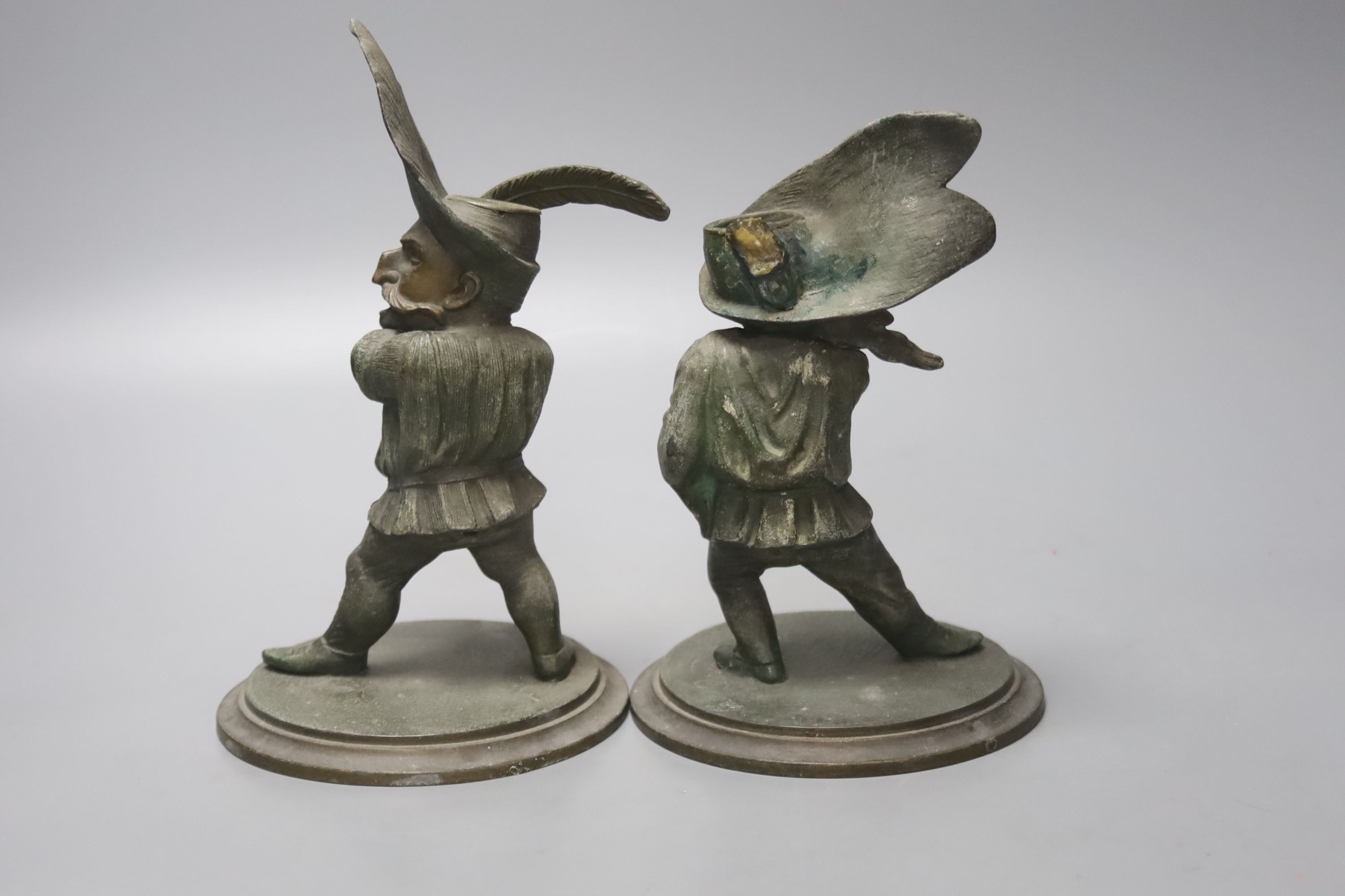 A pair of novelty duelling spelter figural candlesticks